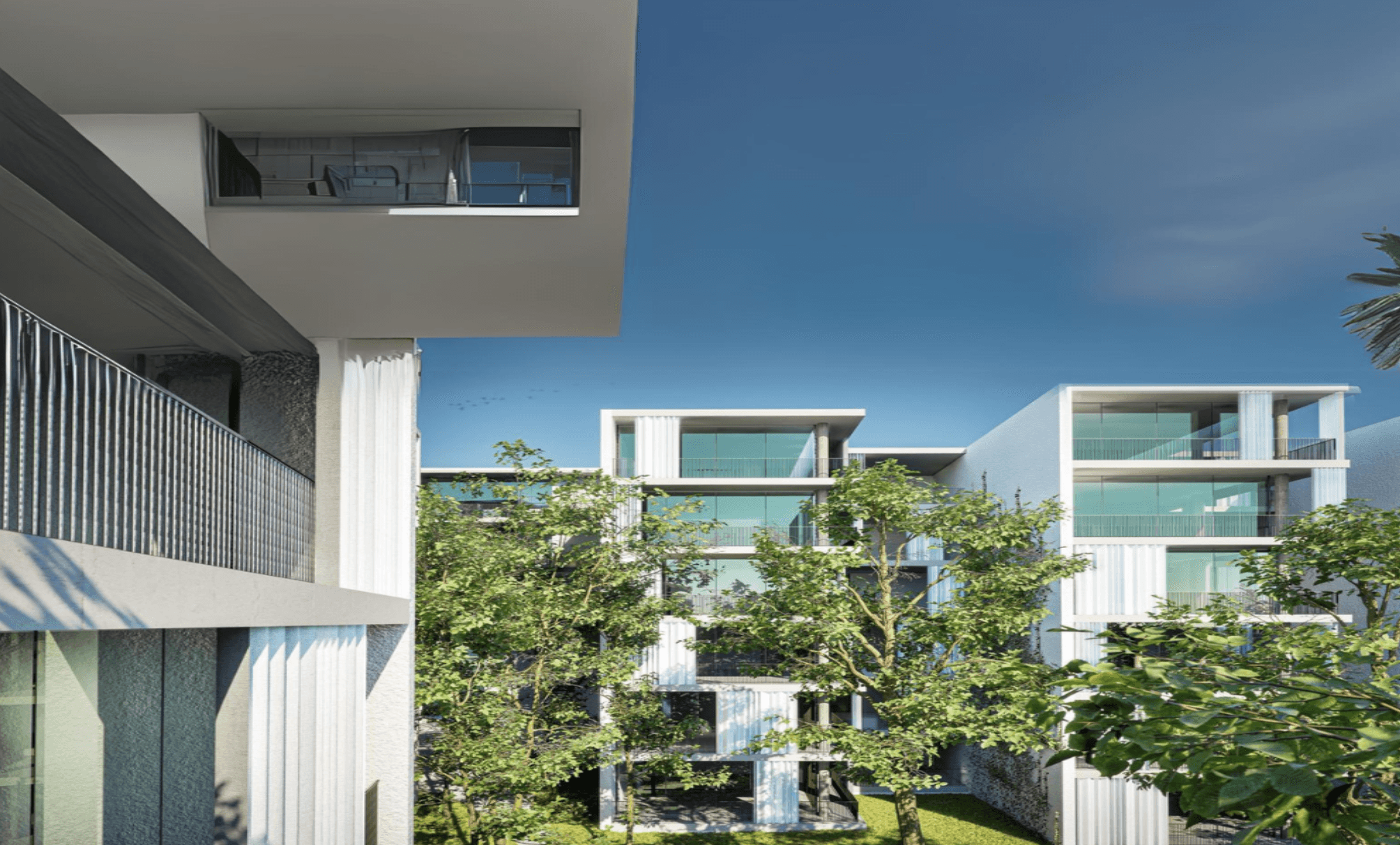 Modern luxury balcony with glass railing overlooking lush greenery and sleek white residences.
